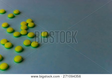 Small Yellow Orange Beautiful Medical Pharmaceptic Round Pills, Vitamins, Drugs, Antibiotics On A Bl