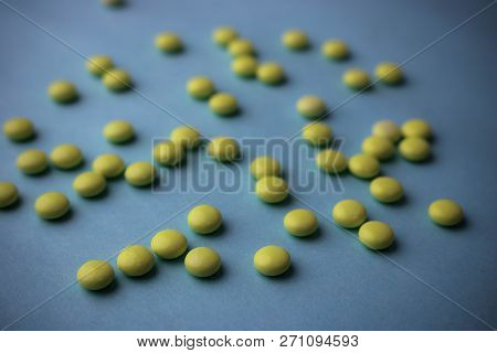 Small Yellow Orange Beautiful Medical Pharmaceptic Round Pills, Vitamins, Drugs, Antibiotics On A Bl