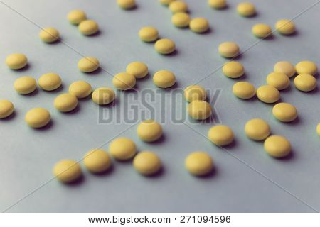 Small Yellow Orange Beautiful Medical Pharmaceptic Round Pills, Vitamins, Drugs, Antibiotics On A Bl