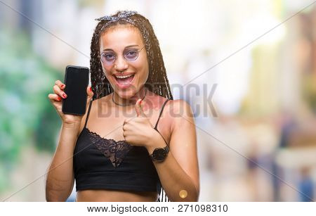 Young braided hair african american with birth mark showing smartphone screen over isolated background happy with big smile doing ok sign, thumb up with fingers, excellent sign