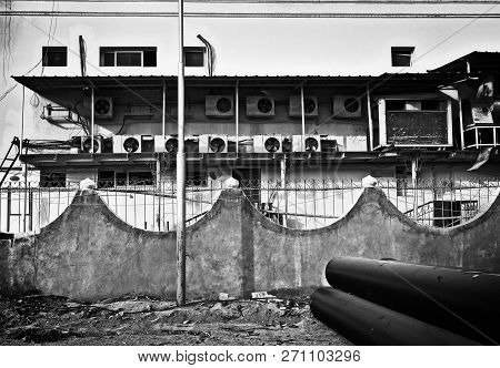 Run Down Backyard. Wall With Dirt And Stains, Old Appliances, Unclean Fence And Other Clutter As The