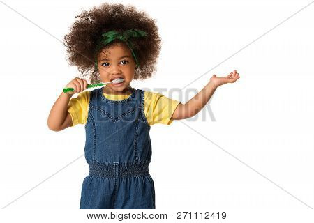 A Little Cute African American Girl Brushing Her Teeth, Isolated Over White Background. Healthy Teet