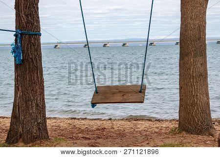 Swing In A Recreation Park And A View From The Shore