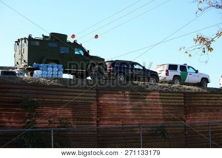 San Ysidro, California - 11/26/2018: Border patrol vehicles and personnel along with other border security and police officers at the US/Mexican border. Tensions are high due to the migrant caravan.