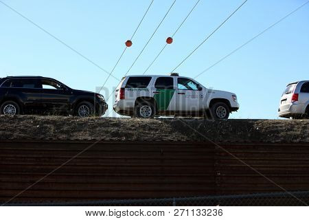 San Ysidro, California - 11/26/2018: Border patrol vehicles and personnel along with other border security and police officers at the US/Mexican border. Tensions are high due to the migrant caravan.