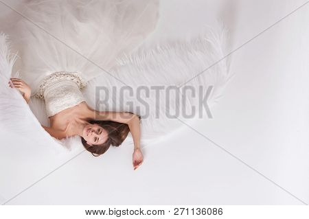 Girl In White Dress With Angel Wings On White Background. Angel-woman