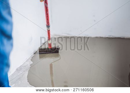 Plasterer During Floor Covering Works With Self-levelling Cement Mortar