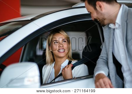 Handsome Salesman At Car Dealership Selling Vehichles