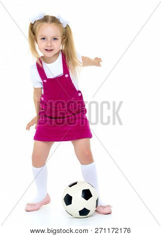 Adorable Little Girl With A Soccer Ball. The Concept Of Childrens Sports, Summer Outdoor Recreation.