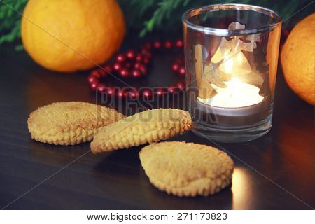 Christmas Cookies With Sugar, Mandarina And A Candle In A Candlestick On The Background Of A Green C