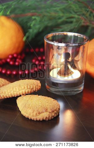 Christmas Cookies With Sugar, Mandarina And A Candle In A Candlestick On The Background Of A Green C