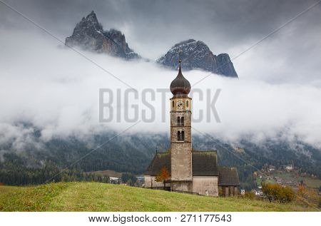 san Valentino church on a foggy late autumn day, Siusi allo Sciliar, Castelrotto, Dolomites, Italy
