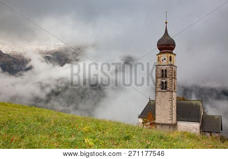 san Valentino church on a foggy late autumn day, Siusi allo Sciliar, Castelrotto, Dolomites, Italy
