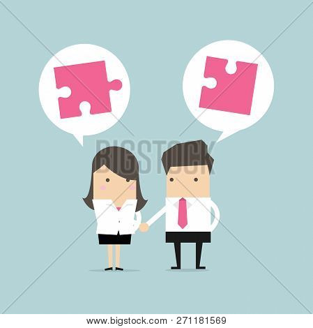 Businessman And Businesswoman Shaking Hand With Jigsaw Conception.