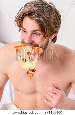 Man Bearded Handsome Bachelor Eating Cheesy Food For Breakfast In Bed. Handsome Man Holds A Piece Of