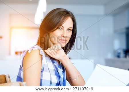 Woman with papers in their living room