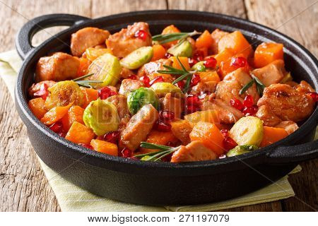 Delicious Chicken Cooked With Vegetables And Rosemary In Pomegranate Sauce Close-up In A Pan. Horizo