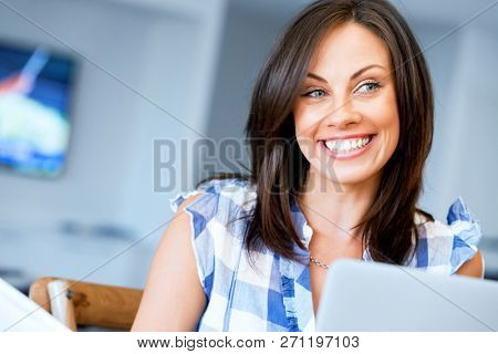 Woman with papers in their living room