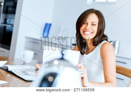 Woman with papers in their living room