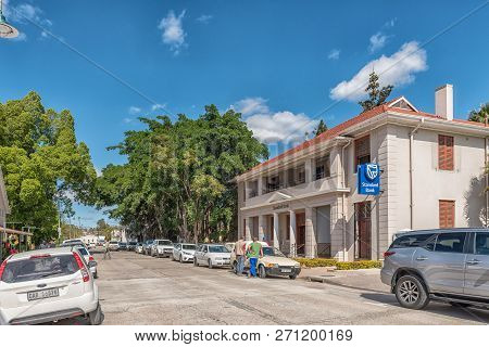 Clanwilliam, South Africa, August 22, 2018: A Street Scene, With A Bank, People And Vehicles, In Cla
