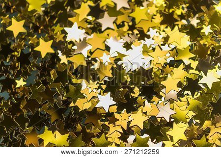Golden Confetti Stars Scattered On The Surface.