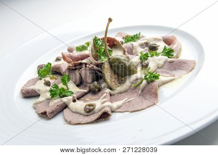 Dish Of Veal Slices With Mayonnaise Of Tuna And Capers Isolated On White Background