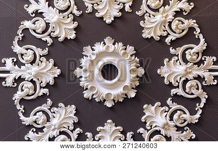 Decorative Gypsum Pilasters On A Brown Background.