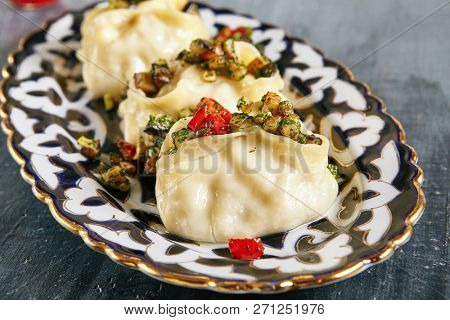 Manti, Mantu or Manty with Fried Vegetables and Spices Close Up. Vegan, Vegetarian Dumplings, Momos, Jiaozi, Dyushbara, Sikkim, Darjeeling, Ha Gao, Mandu, Manti, Pierogi, Xiao Long Bao Or Wontons