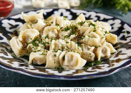 Famous Uzbek Lamb and Beef Dumplings Called Chuchvara Close Up. Asian Ravioli with Minced Meat also known as Pelmeni, Gyoza, Dim Sum, Jiaozi, Momo, Tortellini, Pierogi, Varenyky or Mandu