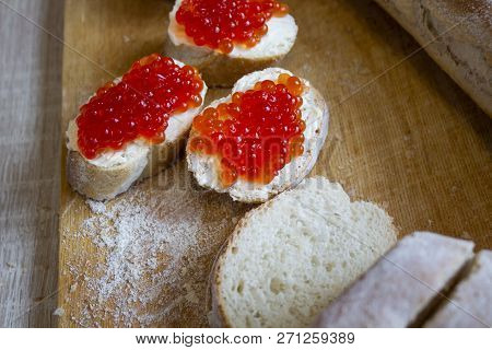 Three Pieces Of Baguette With Butter And Red Caviar On The White Background. Red Caviar Sandwiches.t