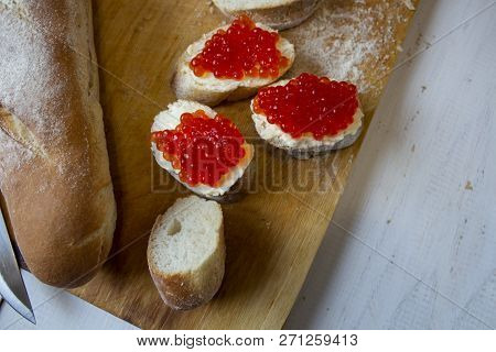 Three Pieces Of Baguette With Butter And Red Caviar On The White Background. Red Caviar Sandwiches.t