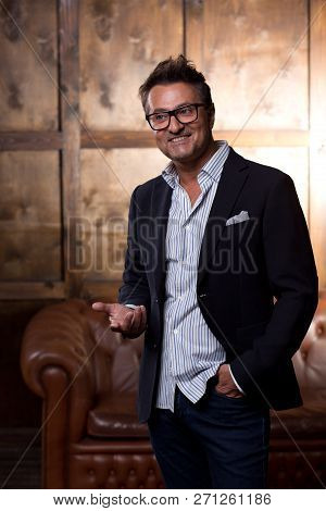 Waist Up Of The Cheerful European Man Wearing Stylish Clothes And Smiling While Standing Alone