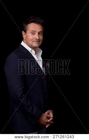 Calm Curious Middle Aged Businessman In Elegant Clothes Smiling While Standing Against The Black Bac