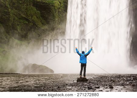Single Man Standing Near Scogafoss Waterfall In Iceland And Spread His Hands. Travel Summer Nordic C