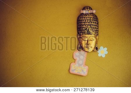 Golden Closed-eye Mask With Flower Crown And Number One. Yellow, Ocre Background