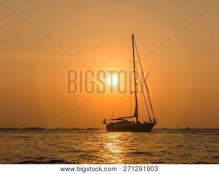 A Boat Silhouette Against Sunset Sky At Mutiara Beach