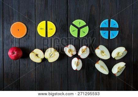 Colorful Math Fractions And Apples As A Sample On Brown Wooden Background Or Table. Interesting Math