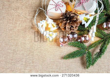 Top View Gift Box Hand Made With Brown Paper Tight With Red Ans White Ribbin, Green Leaf Of Pine Tre