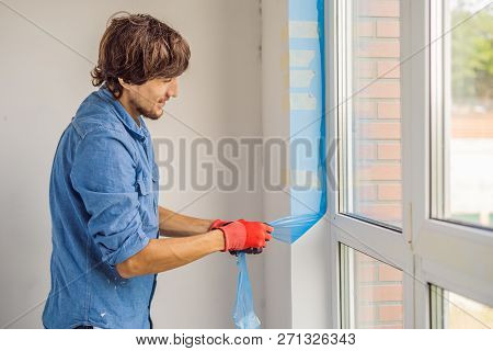 Man In A Blue Shirt Does Window Installation