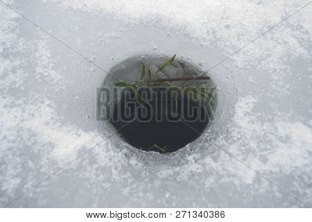 Cut Hole For Ice Fishing With Algae Inside It, Top View