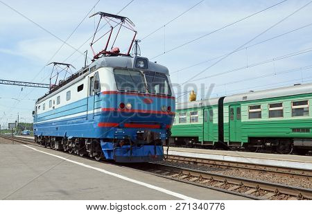 Bulk Passenger Electric Locomotive On The Station Near A Plate With The Inscription 