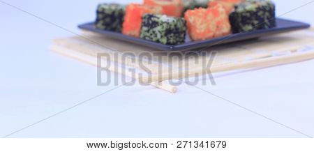 Different Types Of Maki Sushi On A Black Plate