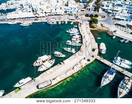 Spectacular airview of small yachts moored at berth in Naoussa port at sunny summer day, Paros island, Greece