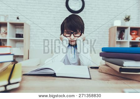 Child Is Doing Homework. Child Is A Little Black Haired Boy. Boy Wearing A Glasses. Boy Is Upset. Ch