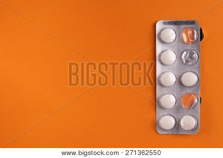 Medical Capsules And Pills On A Orange Background, Close-up, Top View, With Copy Space.