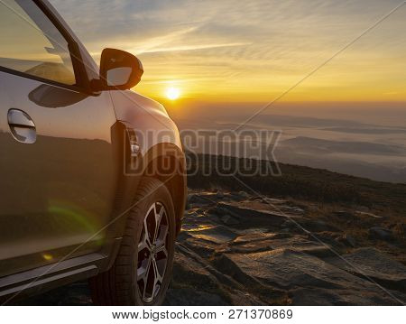 Suv On The Mountain Top At Sunrise