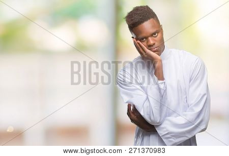 Young arabic african man wearing traditional djellaba over isolated background thinking looking tired and bored with depression problems with crossed arms.
