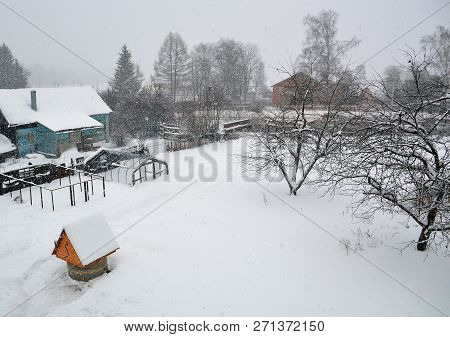 Snow-covered Courtyard Of The House In The Village Overcast Winter Day In The Snow