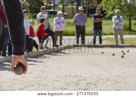 Senior People Prepared To Throw The Boules Ball In A Park In Outdoor Play
