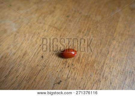 Pill Of Lutein Dietary Supplement On Wood